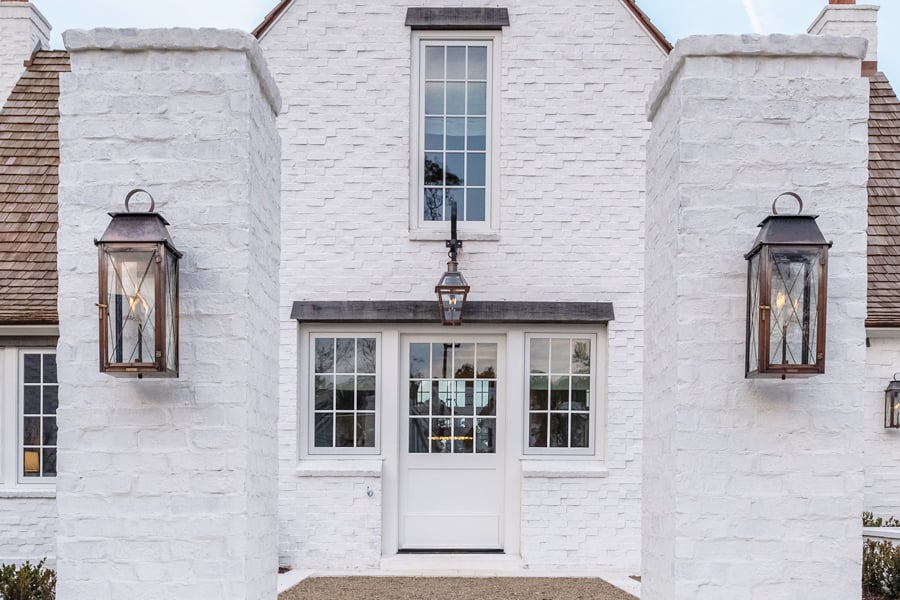 Entry way of classic stone home with hanging lantern lights